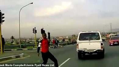 Terrifying moment South African motorist runs over child carjacker who aimed a gun at him… four months after crooks attacked his vehicle with axes on same stretch of road